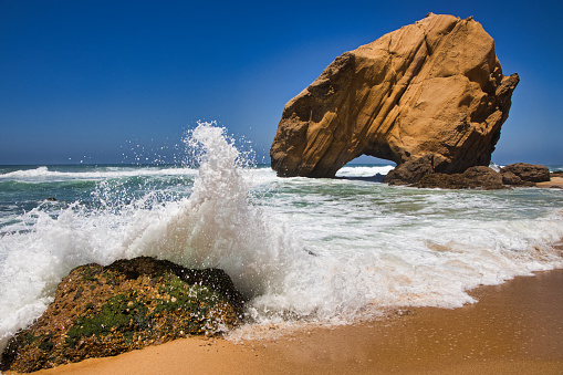 Rocks and waves at the beach of Santa Cruz in Portugal