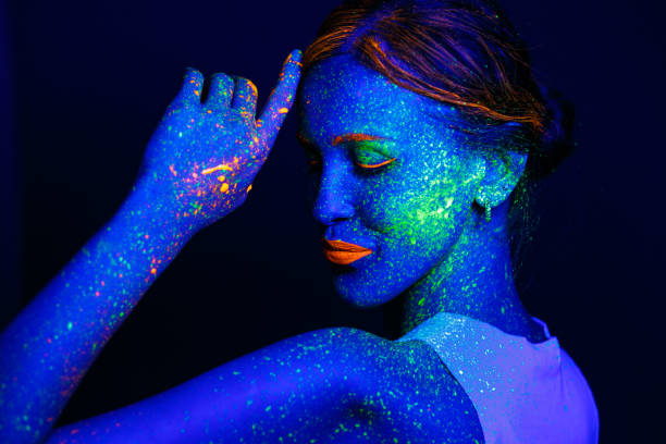 istock Portrait painted with fluorescent makeup under the ultraviolet 1277744361