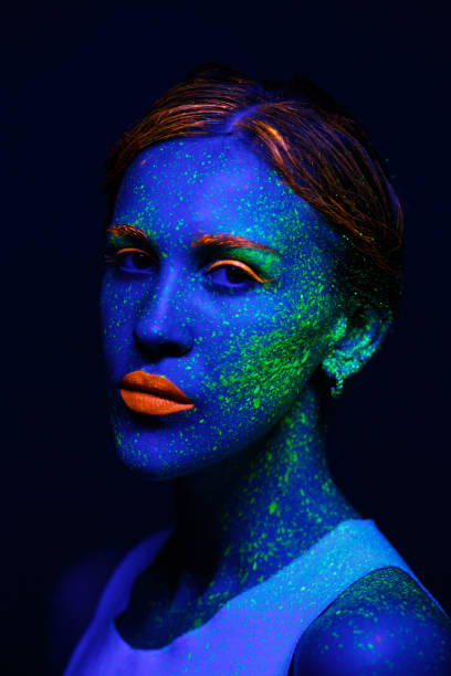 istock Portrait painted with fluorescent makeup under the ultraviolet 1277744440