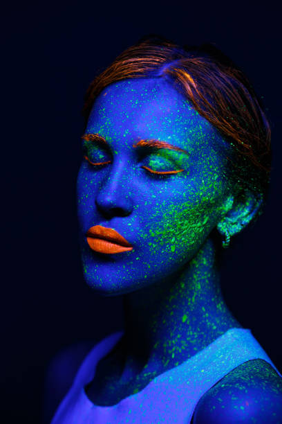 istock Portrait painted with fluorescent makeup under the ultraviolet 1277744479