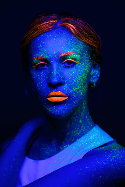 istock Portrait painted with fluorescent makeup under the ultraviolet 1277744522