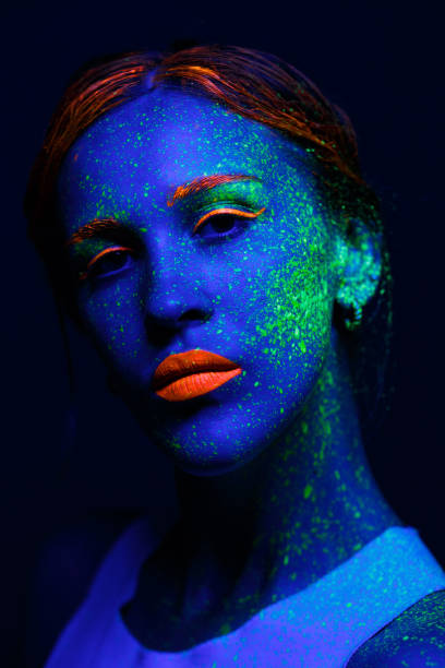 istock Portrait painted with fluorescent makeup under the ultraviolet 1277744587