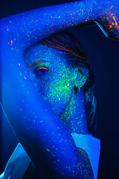 istock Portrait painted with fluorescent makeup under the ultraviolet 1277744632