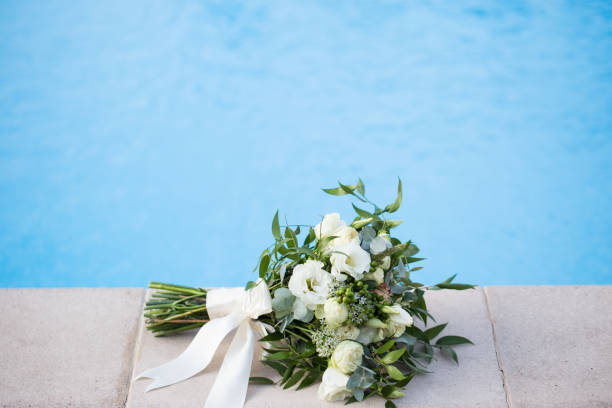istock Wedding bridal bouquet on a blue background close-up 1277745111