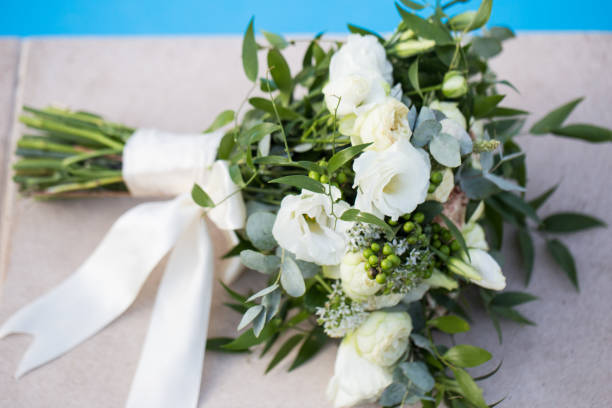 istock Wedding bridal bouquet on a blue background close-up 1277745138