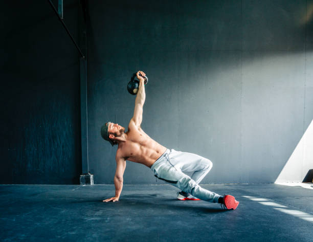 istock Male athlete exercising in cross training gym 1277746749