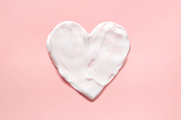 istock Heart moisturizer cream smear on pink background realistic illustration, top view. Concept skincare. Lotion for face or body. 1277746773