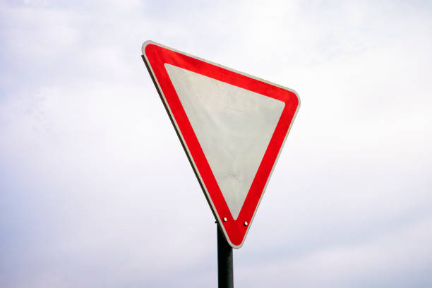 Warning road sign against a blue sky.