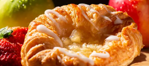 Detailed closeup macro photo of an Apple Danish Pastry, food background.