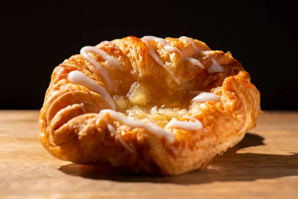 Detailed closeup macro photo of an Apple Danish Pastry, food background.