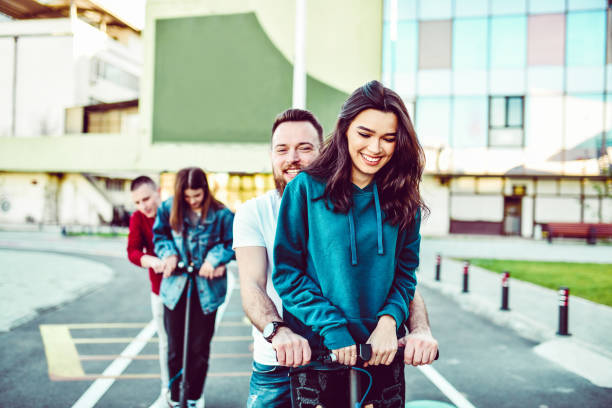 istock Males Riding With Their Girlfriends On Electric Scooters 1277748542