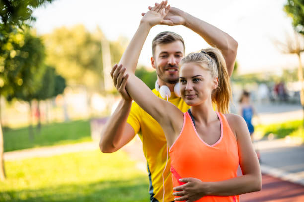 istock Two people exercising outdoor in park 1277748625