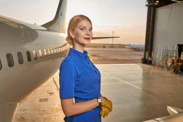 istock Friendly mirthful airline hostess waiting for the working day 1277750445