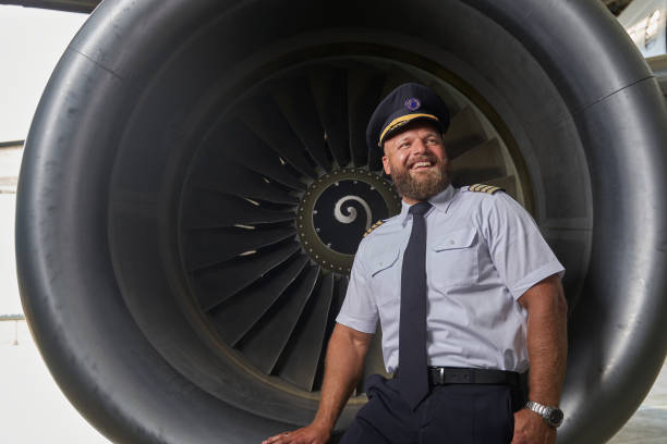 istock Happy optimistic pilot posing on the plane turbine 1277750452
