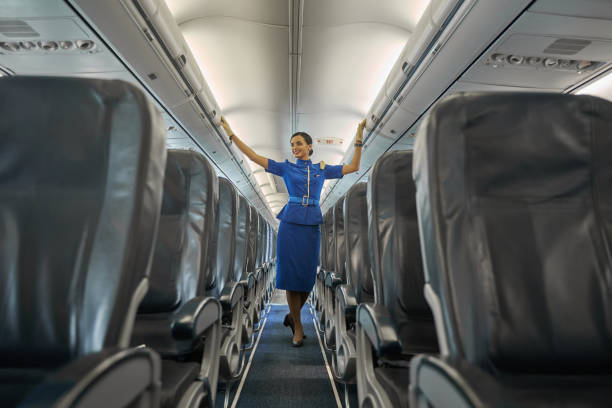 istock Contented professional flight hostess smiling in aircraft cabin 1277750506