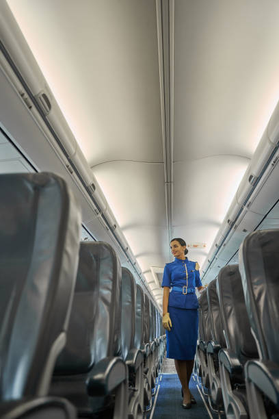 istock Mirthful stewardess looking ready to welcome the passengers 1277750526