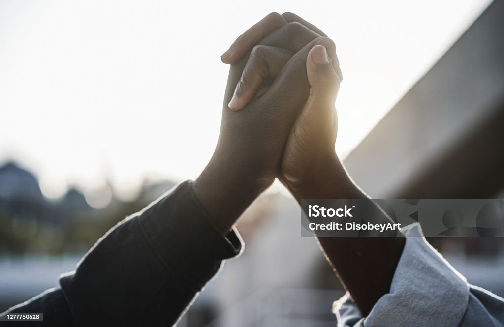 Black people holding hands during protest for no racism - Empowerment and equal rights concept Anti-racism Stock Photo