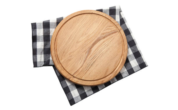 istock Empty pizza board and tablecloth on wooden deck table with napkin 1277750755