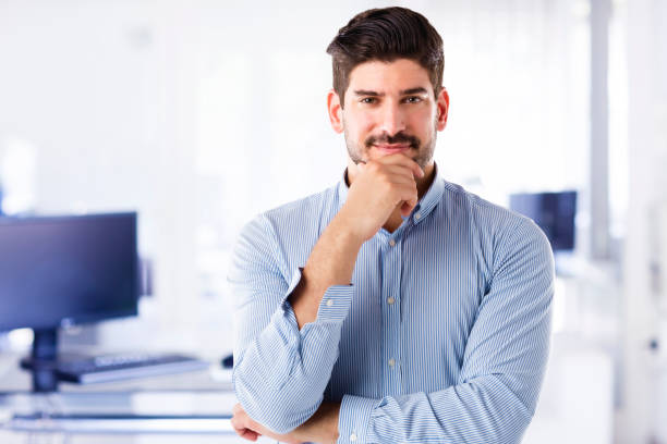 istock Confident businessman close-up portrait while standing at the office 1277751093