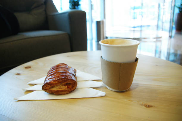 istock cappuccino in paper cup. cappuccino and cake on the table 1277752225
