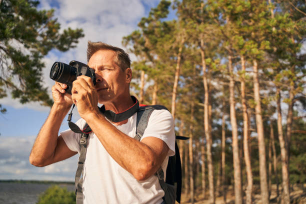 istock Man taking photos while hiking in wood 1277754030