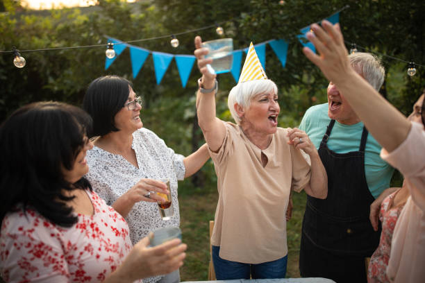 istock Old friends having fun time on birthday party at backyard 1277754060