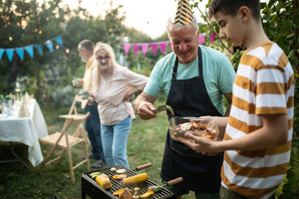 istock Senior man making barbeque for his friends during party at backyard 1277756215