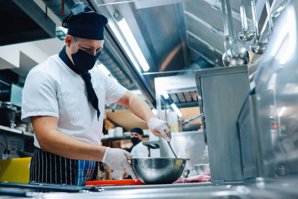 istock Chef cooking in the restaurant kitchen during the pandemic 1277757911