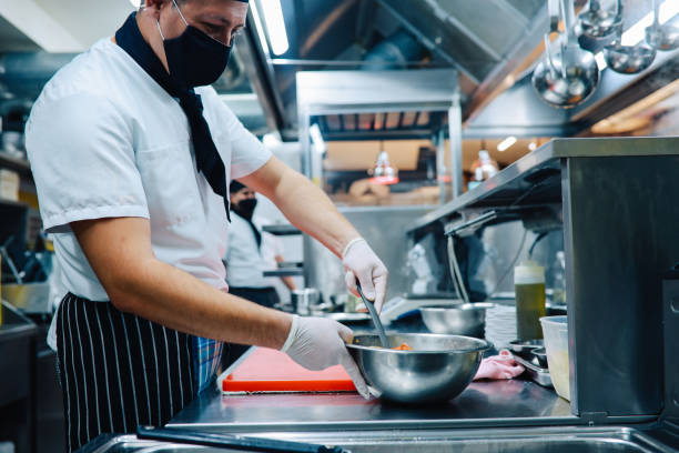 istock Chef preparing food in the restaurant kitchen during the pandemic 1277759106