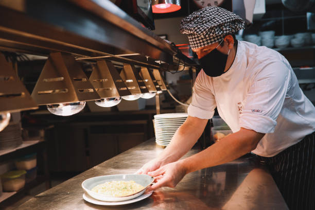 istock Chef preparing food in the restaurant kitchen during the pandemic 1277759161