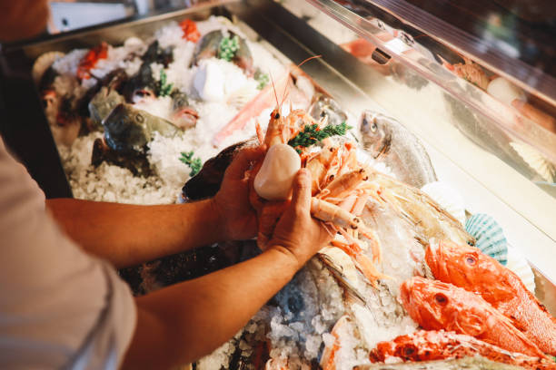 Close up of chef's hands preparing seafood