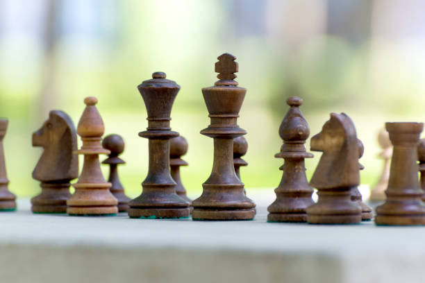 istock Chess Pieces standing on the Chessboard before the outdoor tournament. 1277761121
