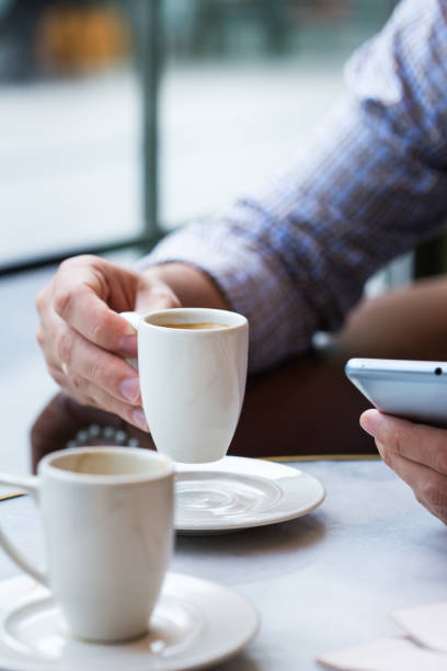 istock Businessman sitting in cafe, drinking morning coffee and using smartphone 1277761689