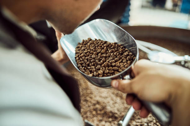istock Young man smelling freshly roasted coffee beans 1277763251