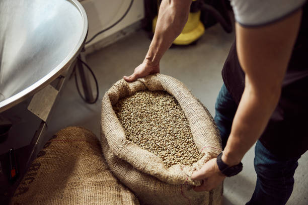 istock Young man holding burlap sack with coffee beans 1277763297