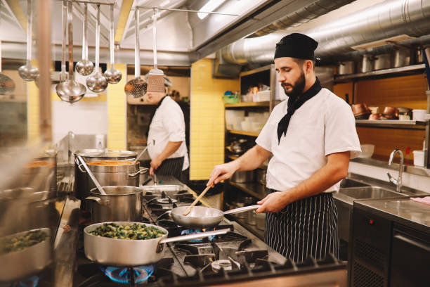 istock Restaurant kitchen coworkers preparing food 1277763437