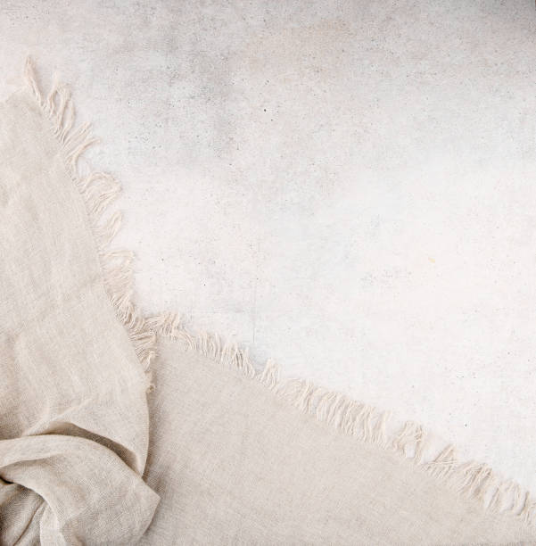 istock Pure washed linen cloth on light grunge stone background. 1277763446