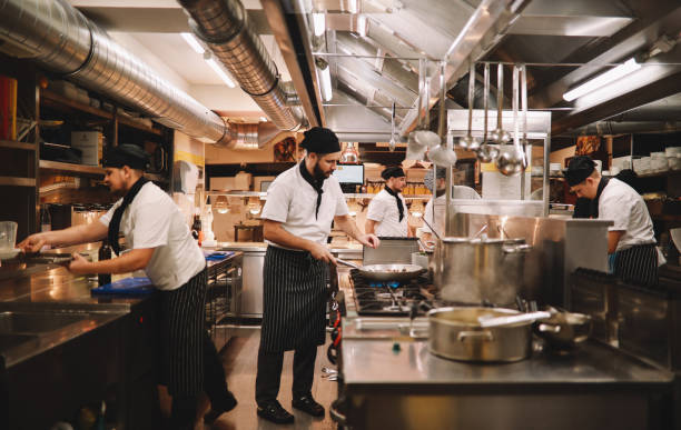 restaurant kitchen crew in action - chef imagens e fotografias de stock