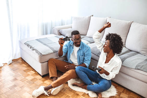 istock Young Couple In Pajamas Playing Video Game Together 1277763813