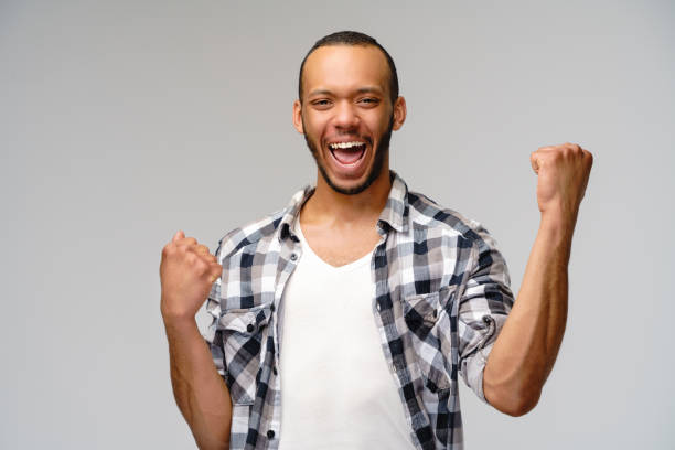 istock Young African-American man yes win gesturing over light grey background 1277764854
