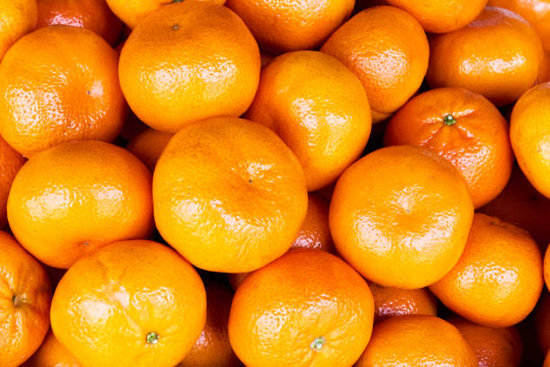 istock Close-up of orange colored shiny mandarins 1277765689