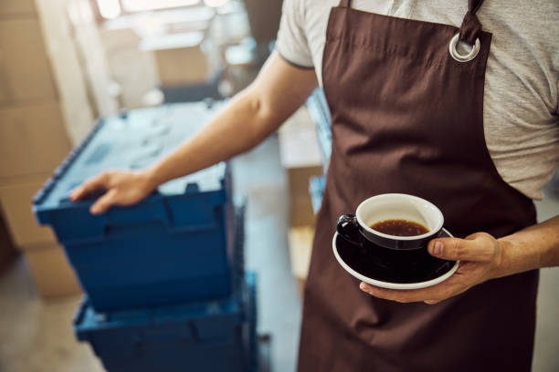 istock Male worker hand holding black cup of coffee 1277765722