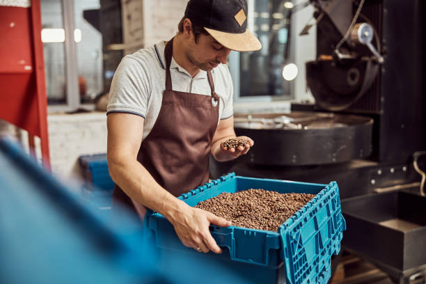 istock Handsome young man holding roasted coffee beans 1277765731