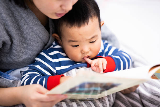 istock Family bedtime. Mom with son reading a picture book 1277766021