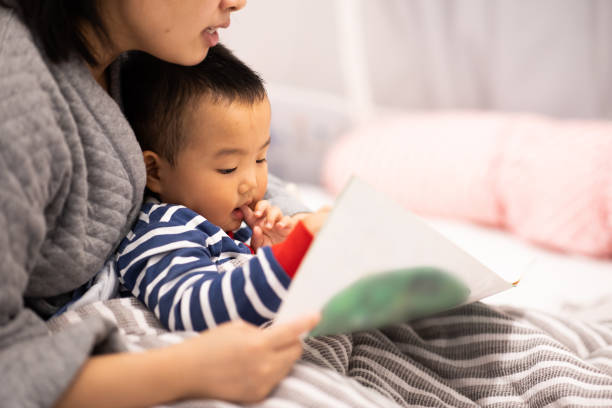 istock Family bedtime. Mom with son reading a picture book 1277766048
