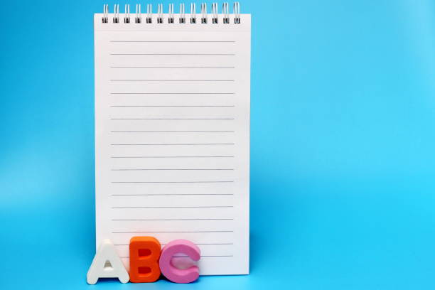 istock ABC- first letters of the English alphabet on a blue background. Blank Notepad page 1277766076