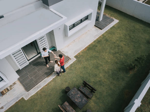 asian chinese couple receiving house keys from real estate agent outside new house - garden key imagens e fotografias de stock