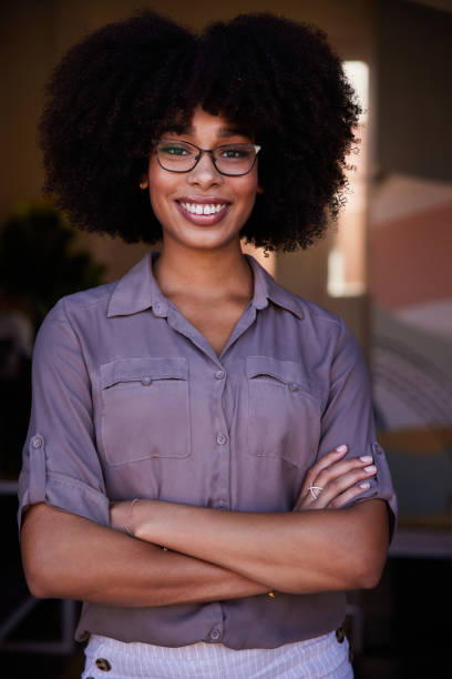 istock Smiling young female entrepreneur standing in her cafe 1277766406