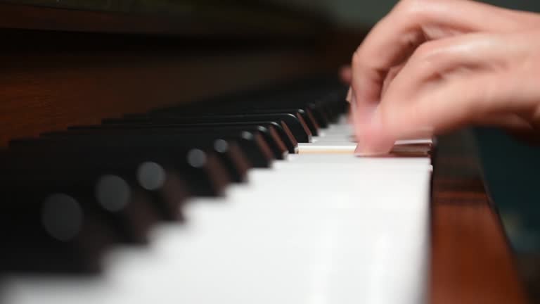 Close-up of woman playing a piano