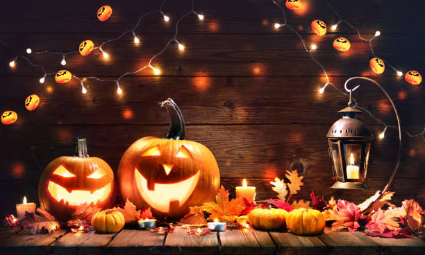 istock Halloween pumpkins with lantern on wooden background 1277767901